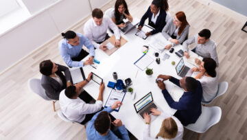 a bpo outsourcing team hard at work in a conference room