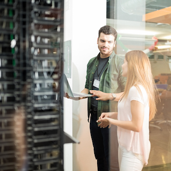 Colleagues discussing cloud communications in a server room