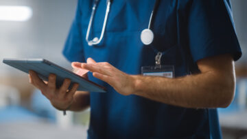 a doctor using a tablet to improve healthcare customer experience